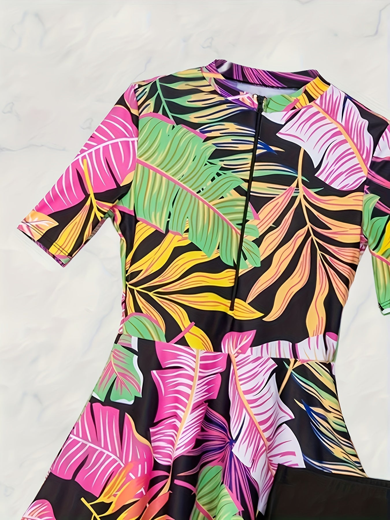 Tropical leaf print high-neck short sleeve rash guard swimsuit set for women, ideal for water sports and beach activities, made with stretchy polyester/elastane blend non-transparent fabric