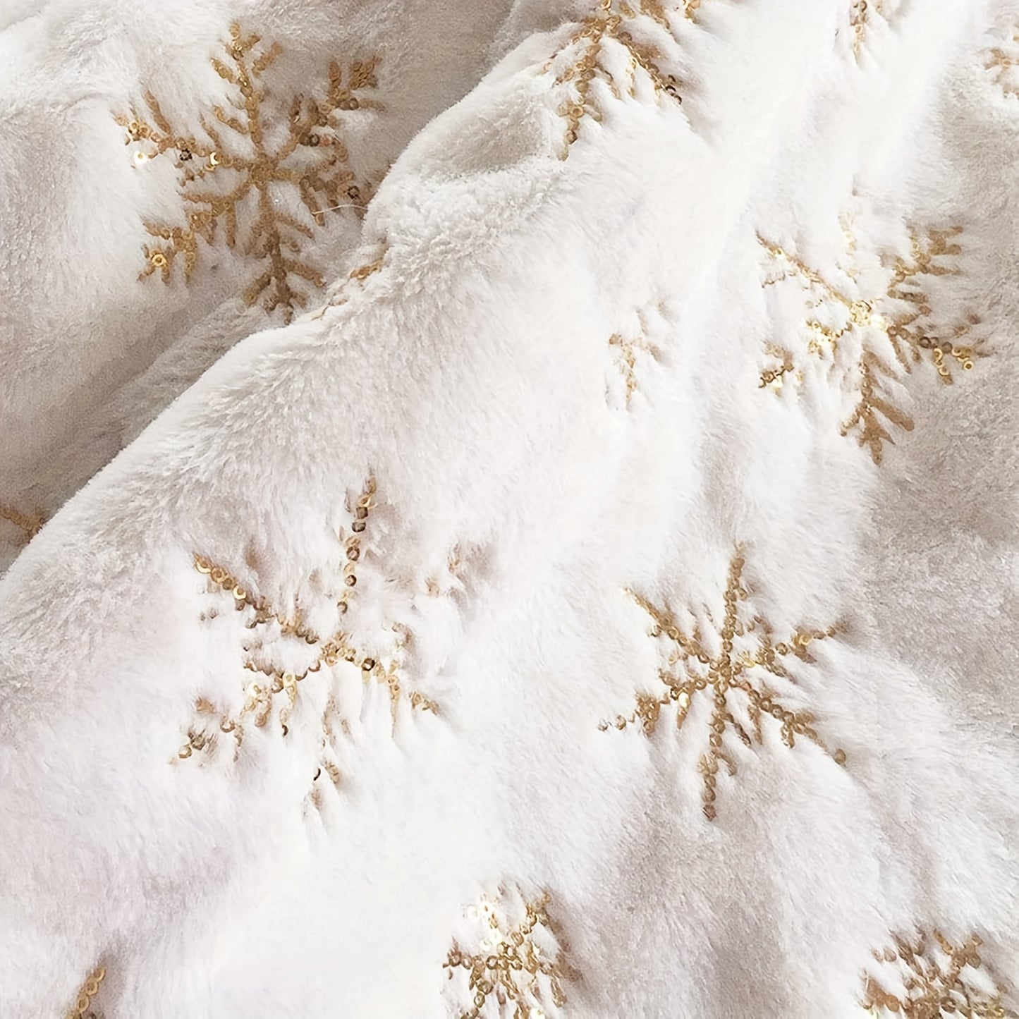 White velvet Christmas tree skirt with golden snowflake embroidery, ideal for Halloween, Christmas, and Valentine's Day. Festive holiday decoration with textured detailing.