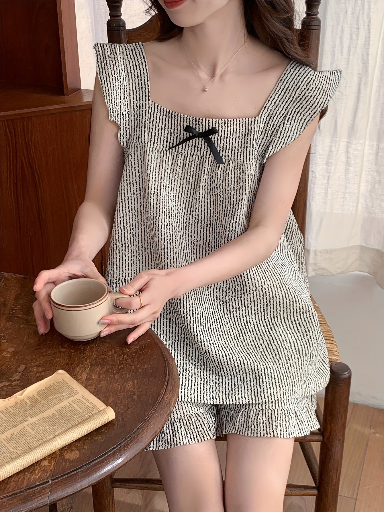 Summer pajama set for women with flutter sleeves and sleeveless top.