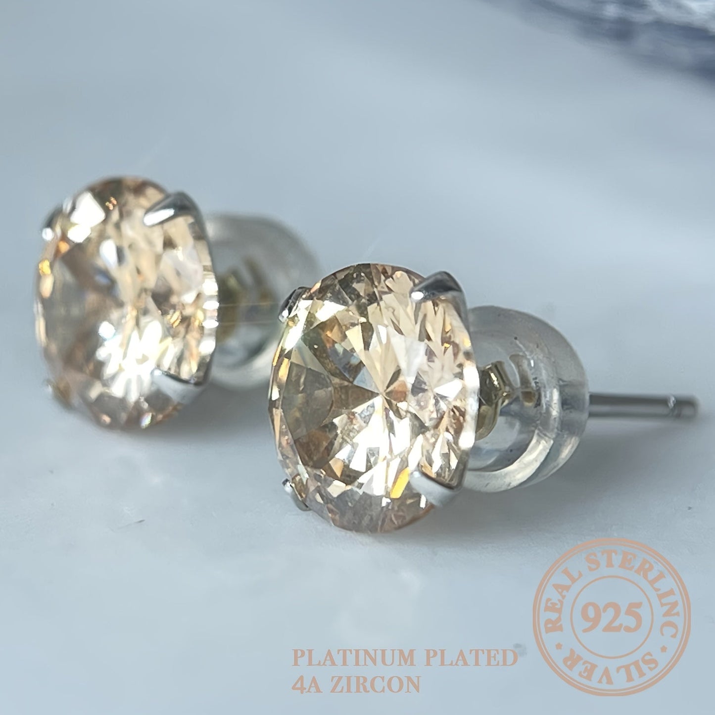 These elegant round champagne-colored earrings are crafted from 925 silver, perfect for everyday wear, traveling, attending parties, or gifting as a stylish and fashionable accessory.