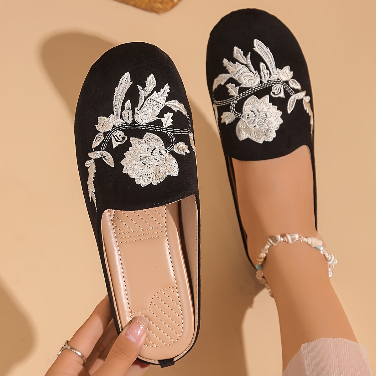 Stylish black embroidered floral mules with soft rubber sole and faux cover lining for comfortable year-round wear.