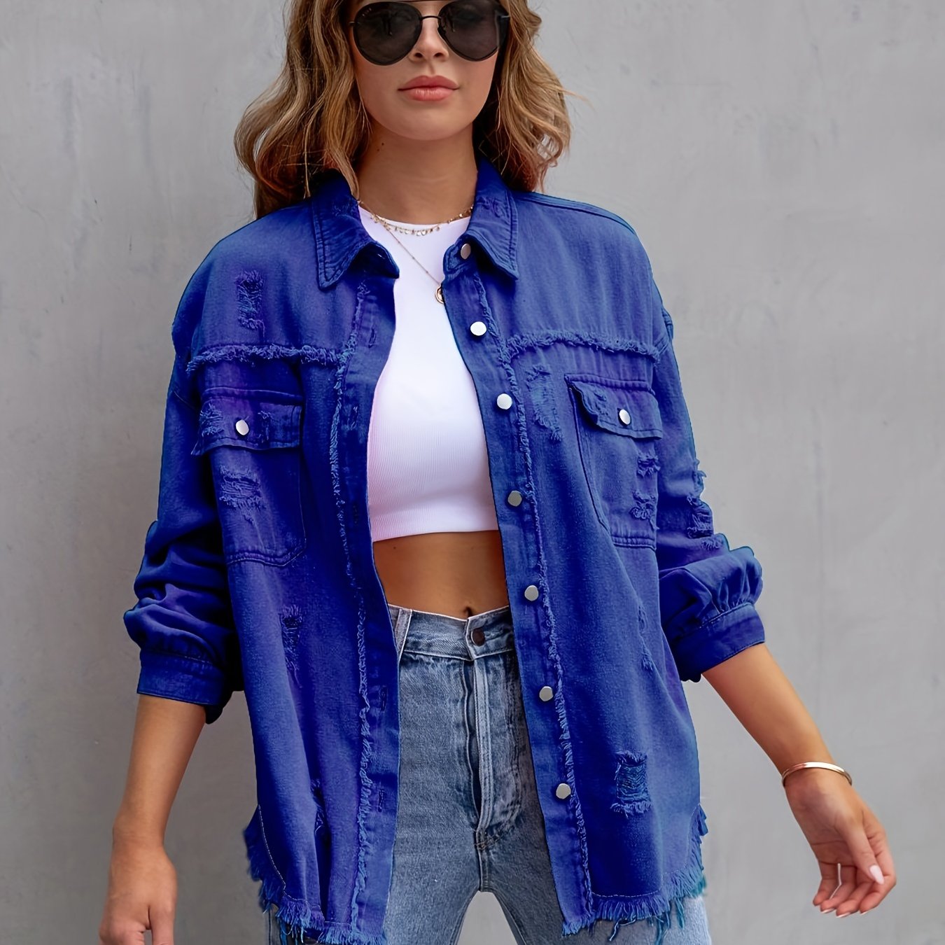 Women's plus size distressed denim jacket with boho style, button detail, and lapel collar made of rayon/viscose blend fabric. Suitable for spring/fall fashion.