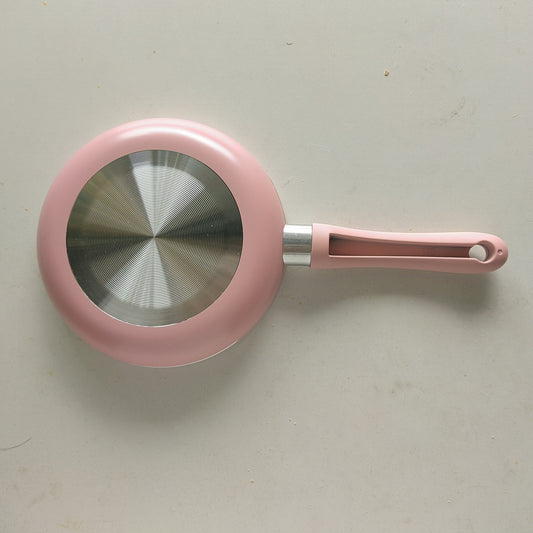 Pink aluminum mini frying pan with a flat bottom and silicone handle, measuring 16.51cm in size. Lightweight and suitable for frying eggs and steaks on a gas stove.