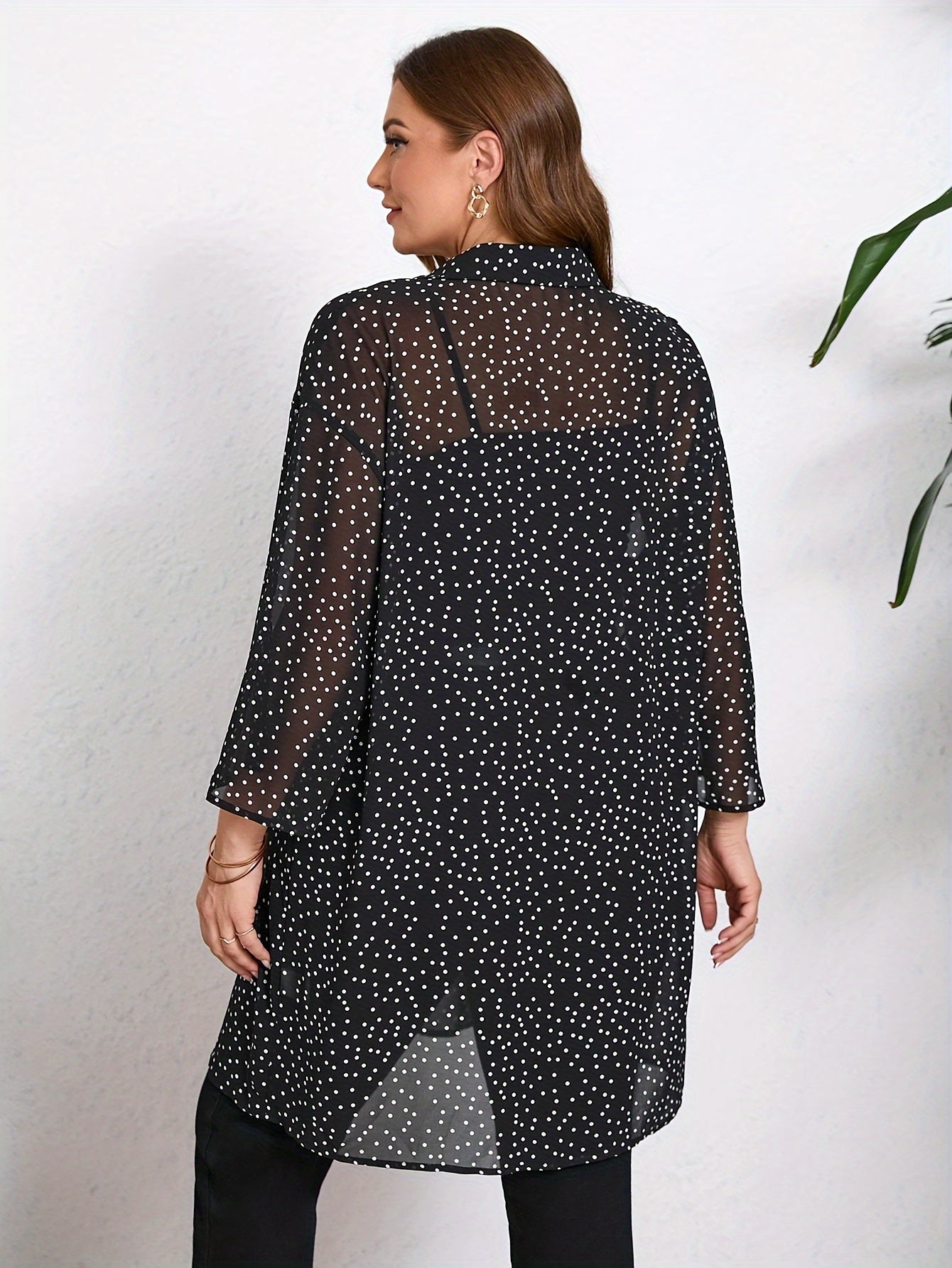 Stylish plus size polka dot blouse with cuffed sleeves. Casual and versatile for all seasons.