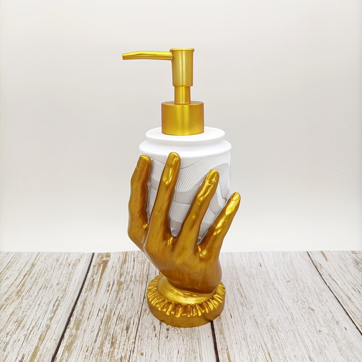 Elegant gold fingerprint resin soap dispenser, mercury-free with textured design. Ideal for bathroom and kitchen decor. Made of resin.