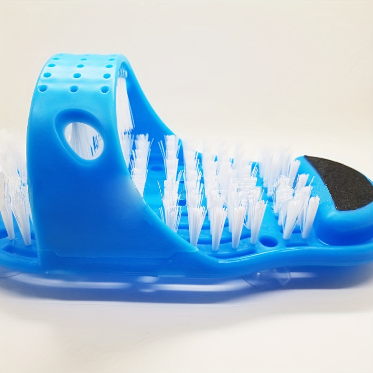 Foot washing brush with suction cup, removes dead skin and massages foot.