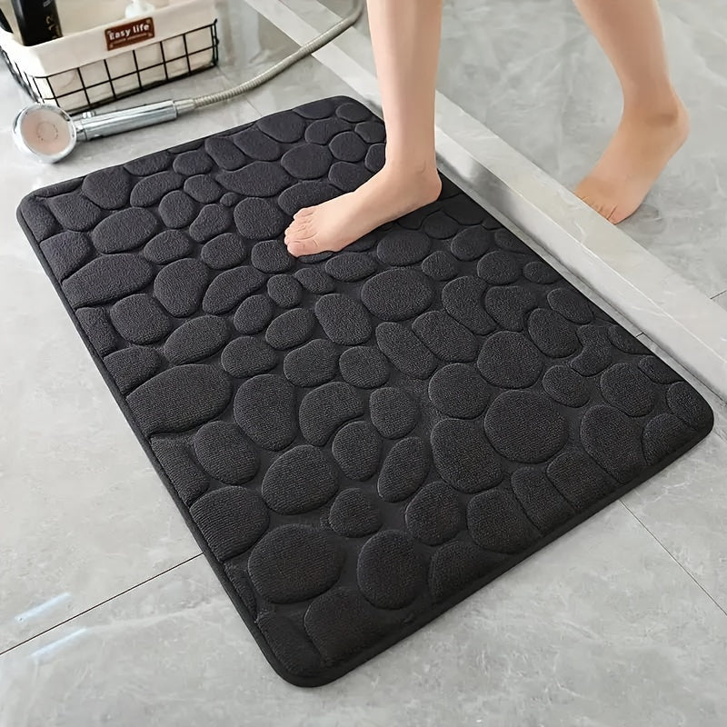 Memory foam bath rug with cobblestone design, ultra-absorbent and anti-slip for home and hotel use. Made of soft coral fleece, this bathroom rug is both practical and stylish.