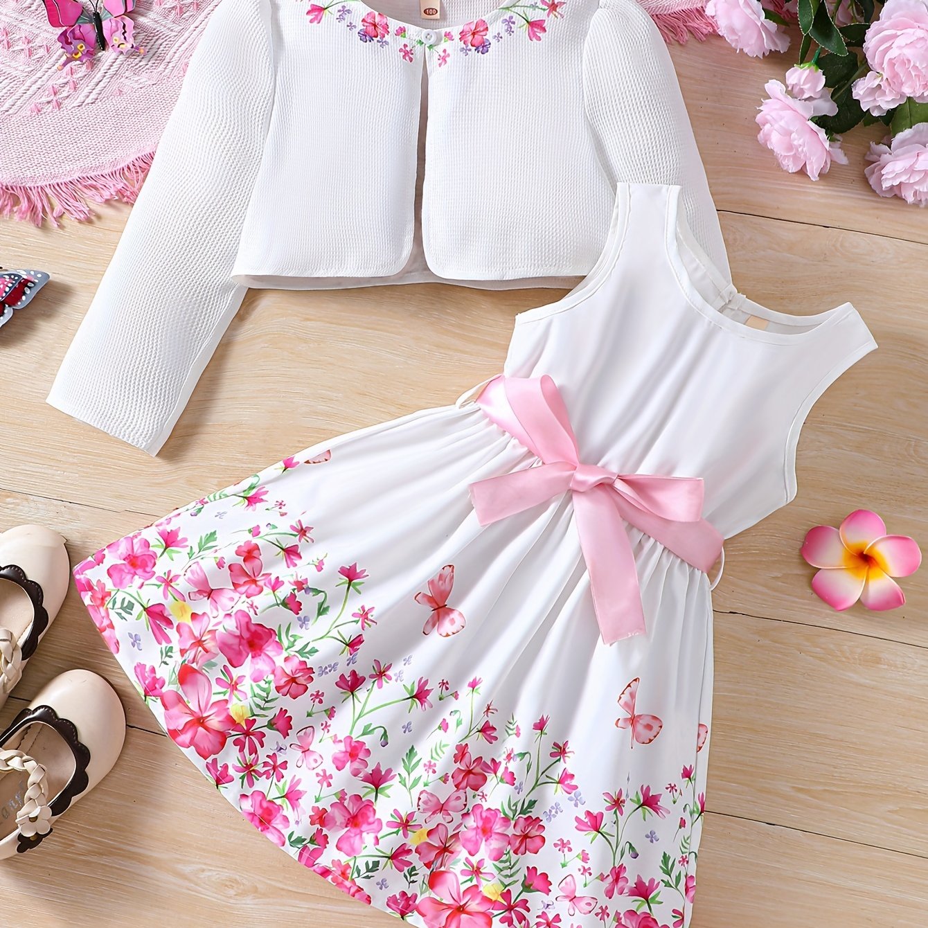 Girls' spring fashion 2-piece set includes floral print dress with belt detail and matching cardigan. Made of 100% polyester, non-stretch woven fabric. Perfect for outdoor wear.