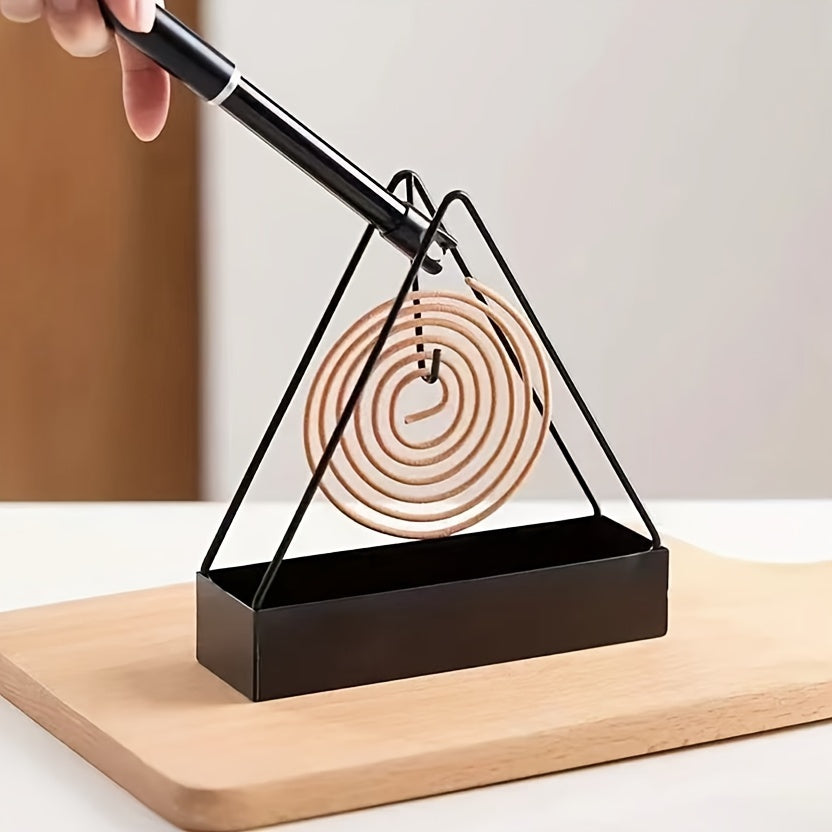 Sleek black metal mosquito coil holder with triangular design incense burner and wooden spiral insert. Ideal for home decor and indoor air freshening. Unsceted and made of metal for a modern touch.