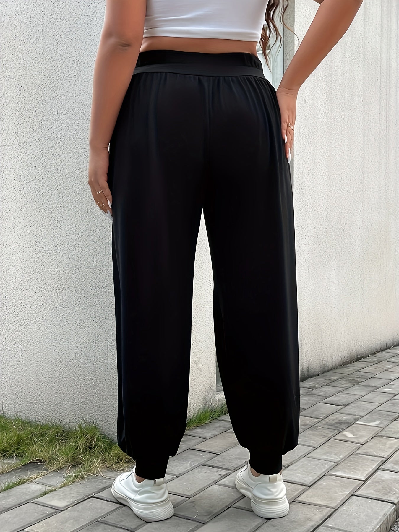 Plus size women's casual black wide-leg pants with a cozy fit and pleated detail. Made from a stretchy polyester blend for comfortable wear. Ideal for spring, summer, and fall. Perfect for