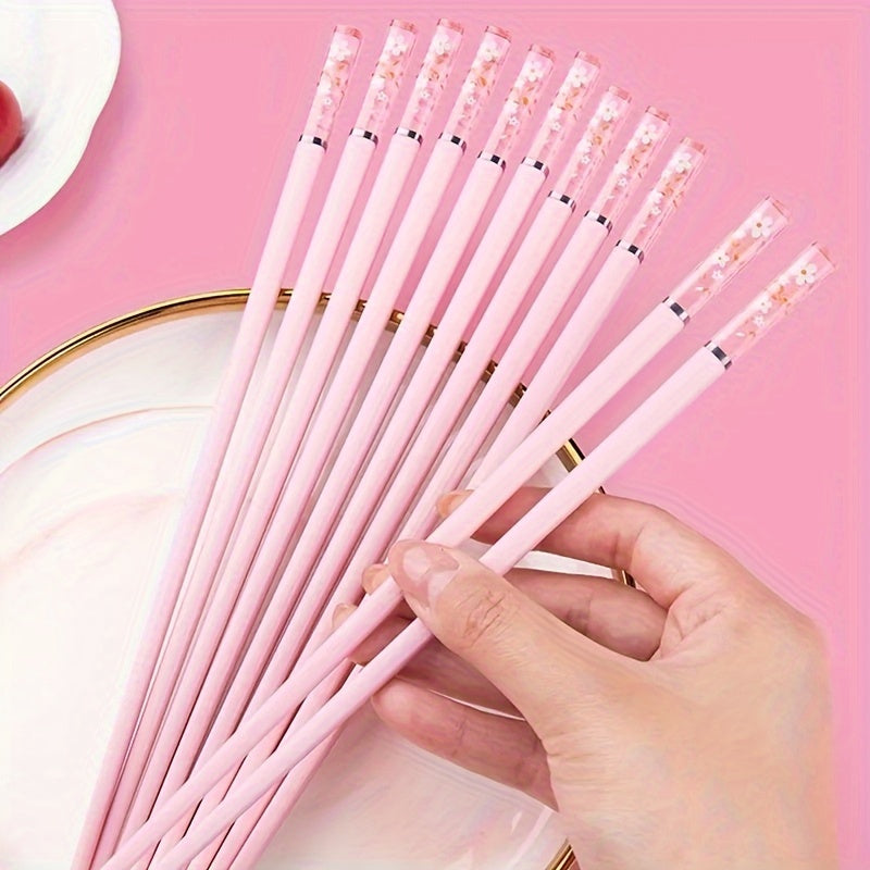 One set of Pink Cherry Flower Amber Chopsticks, ideal for Chinese and Korean style meals such as fast food, sushi, and ramen. Perfect for family meals and reusable kitchen supplies.