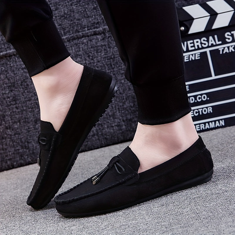 Men's black canvas slip-on loafers with tassel detail, rubber sole, and fabric lining for all seasons. Chic and comfortable canvas shoes.