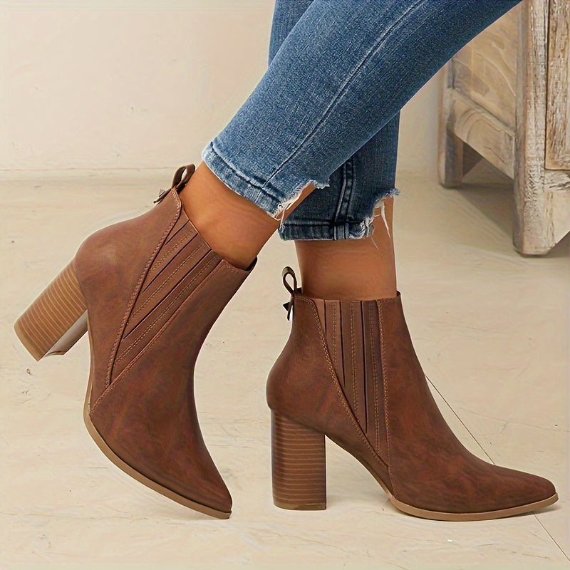 Trendy slip-on ankle boots in solid colors with chunky heels and a pointed toe.