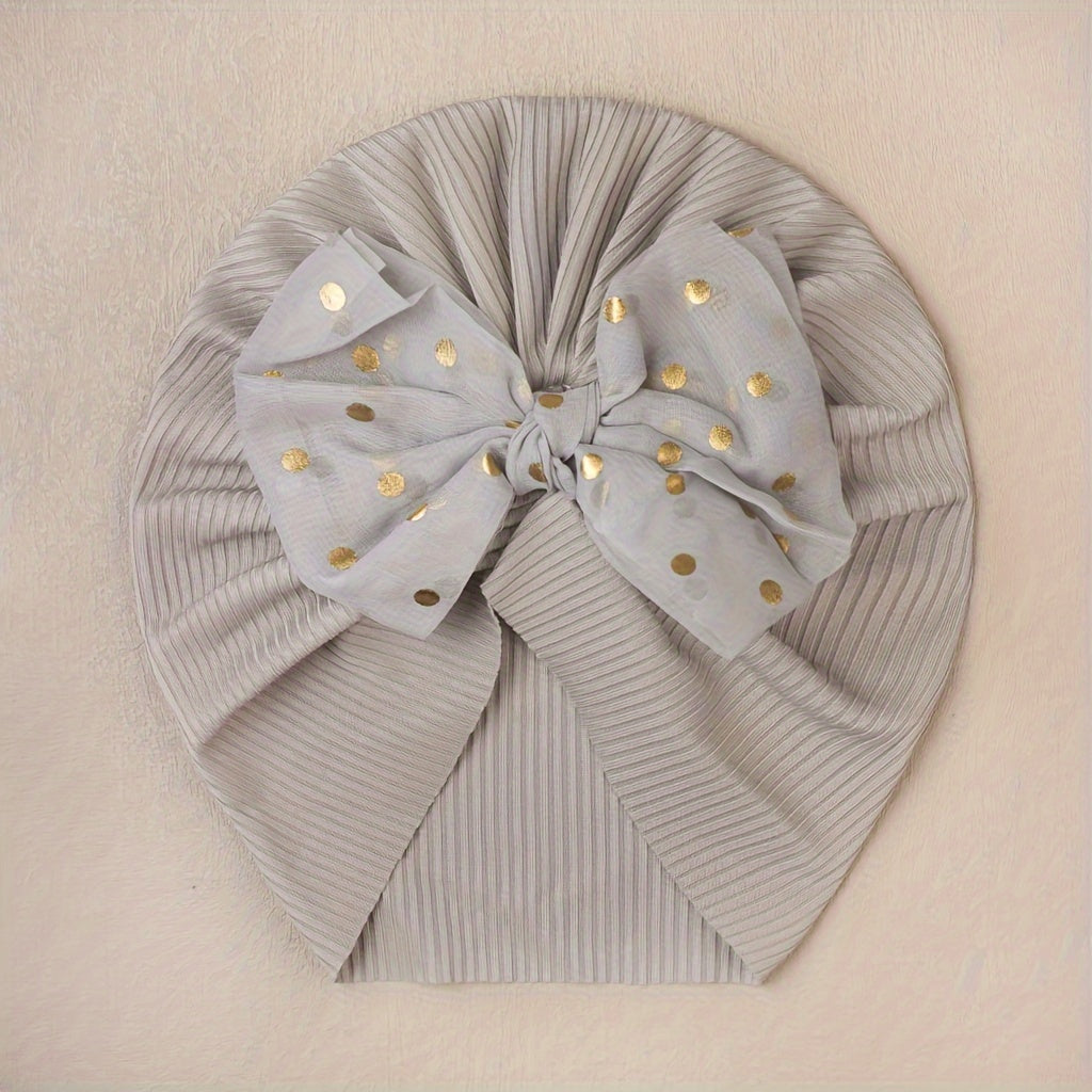 Polka dot printed bow head wrap for newborn infants and toddlers.