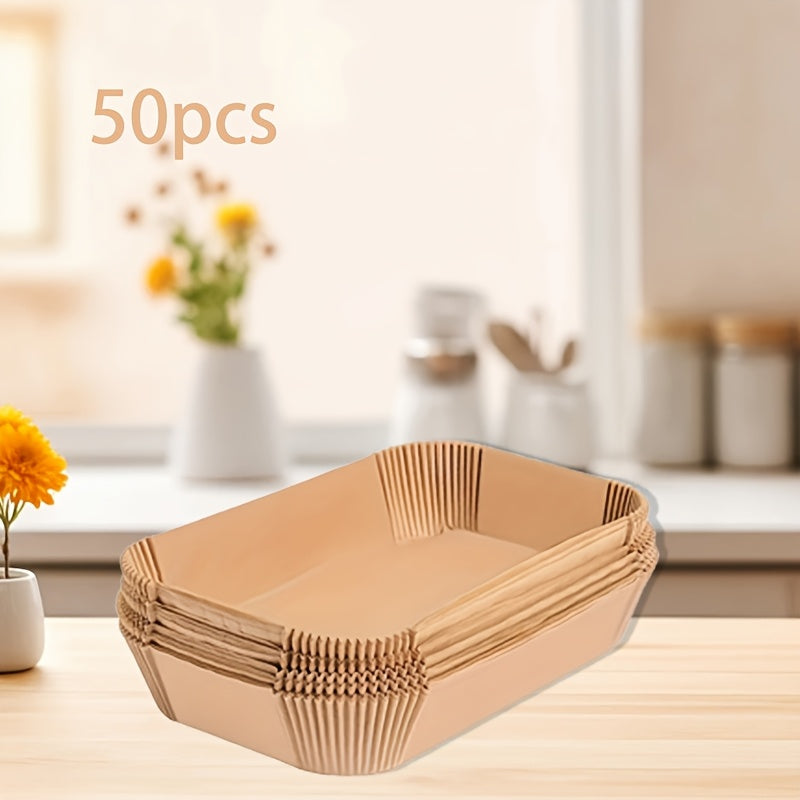 50 pieces of rectangular silicone paper air fryer liners that are disposable and non-stick. These basket mats are ideal for baking, cooking, and serving food with easy cleanup and are space-saving and oven safe. Perfect for home chefs, these air fryer