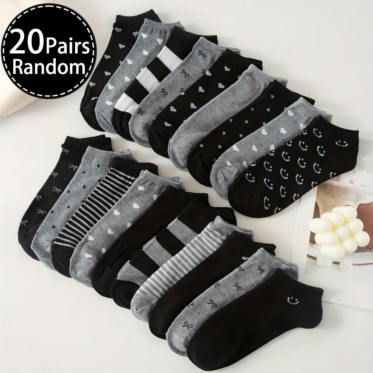 Women's ankle socks in black and grey with assorted geometric patterns. Made from comfortable knit fabric, 95% polyester and 5% spandex. Random style shipping. 10/20 pairs available.