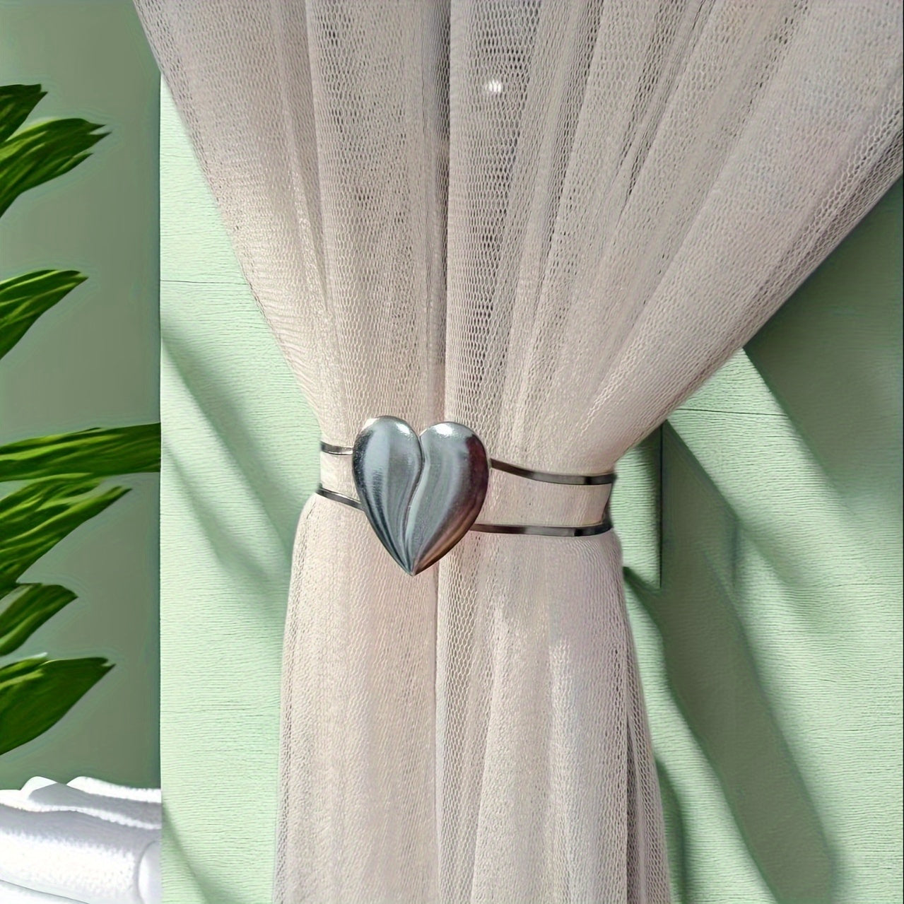 Heart-shaped decor curtain holder made of alloy, featuring a minimalist hollow design. Perfect for use in living rooms, offices, or homes as a stylish and functional curtain accessory.