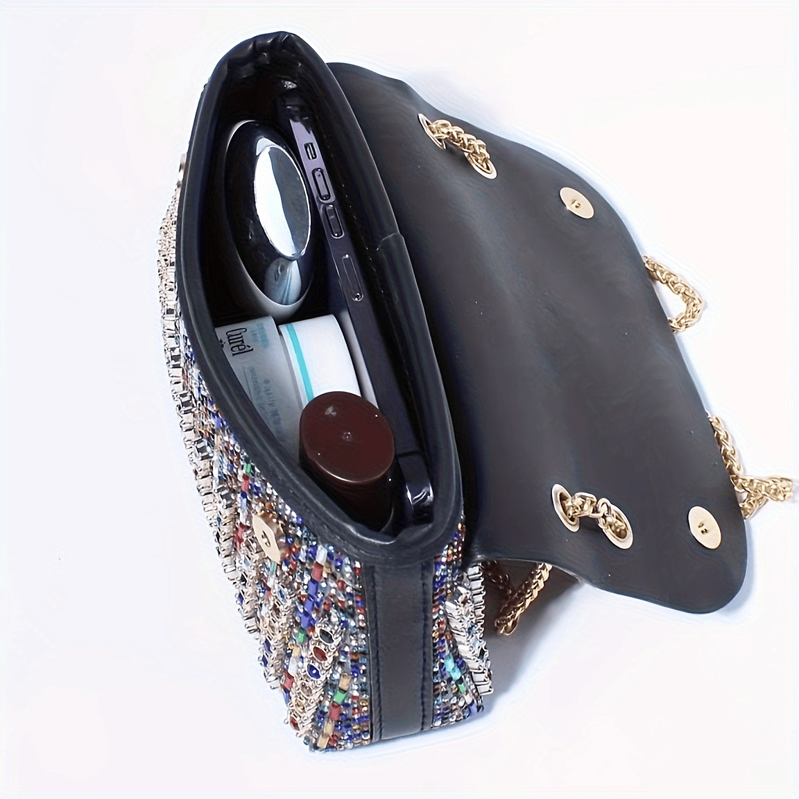 Stylish women's evening clutch with rhinestones and beads, adjustable strap, and magnetic closure, perfect for formal events.