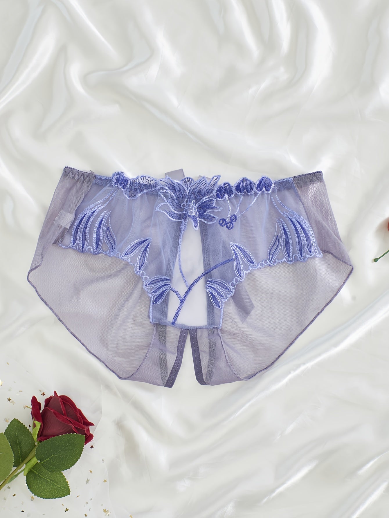 Women's light purple lace mesh panties with floral embroidery feature an open crotch and breathable, sheer design made from a nylon and elastane blend that is hand washable.