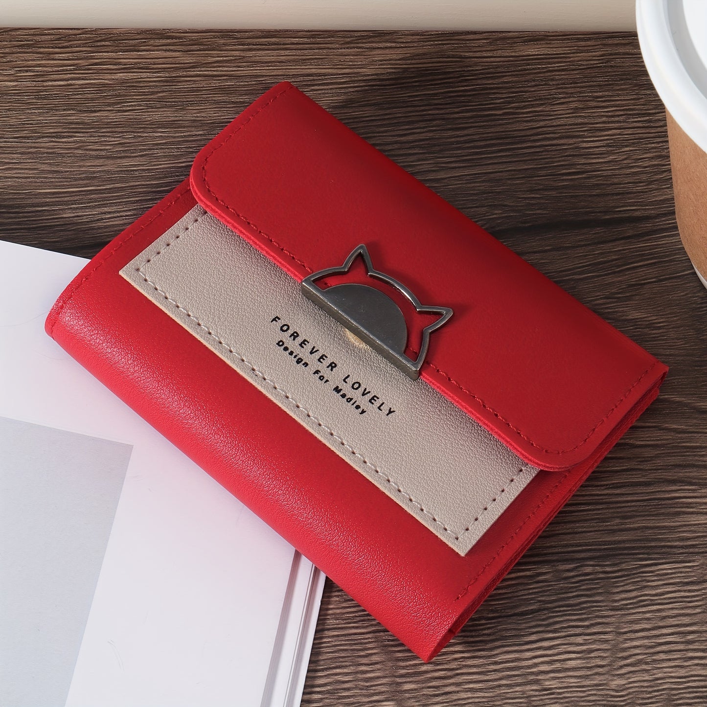 Compact folding wallet with cat metal decor, multiple card slots and coin pocket, available in red, pink, or black.