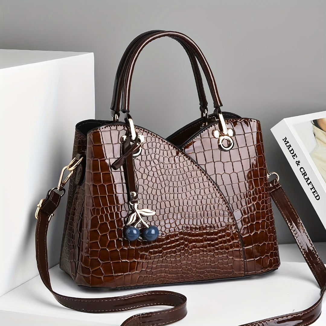 Stylish crocodile embossed tote bag with cherry pendant.