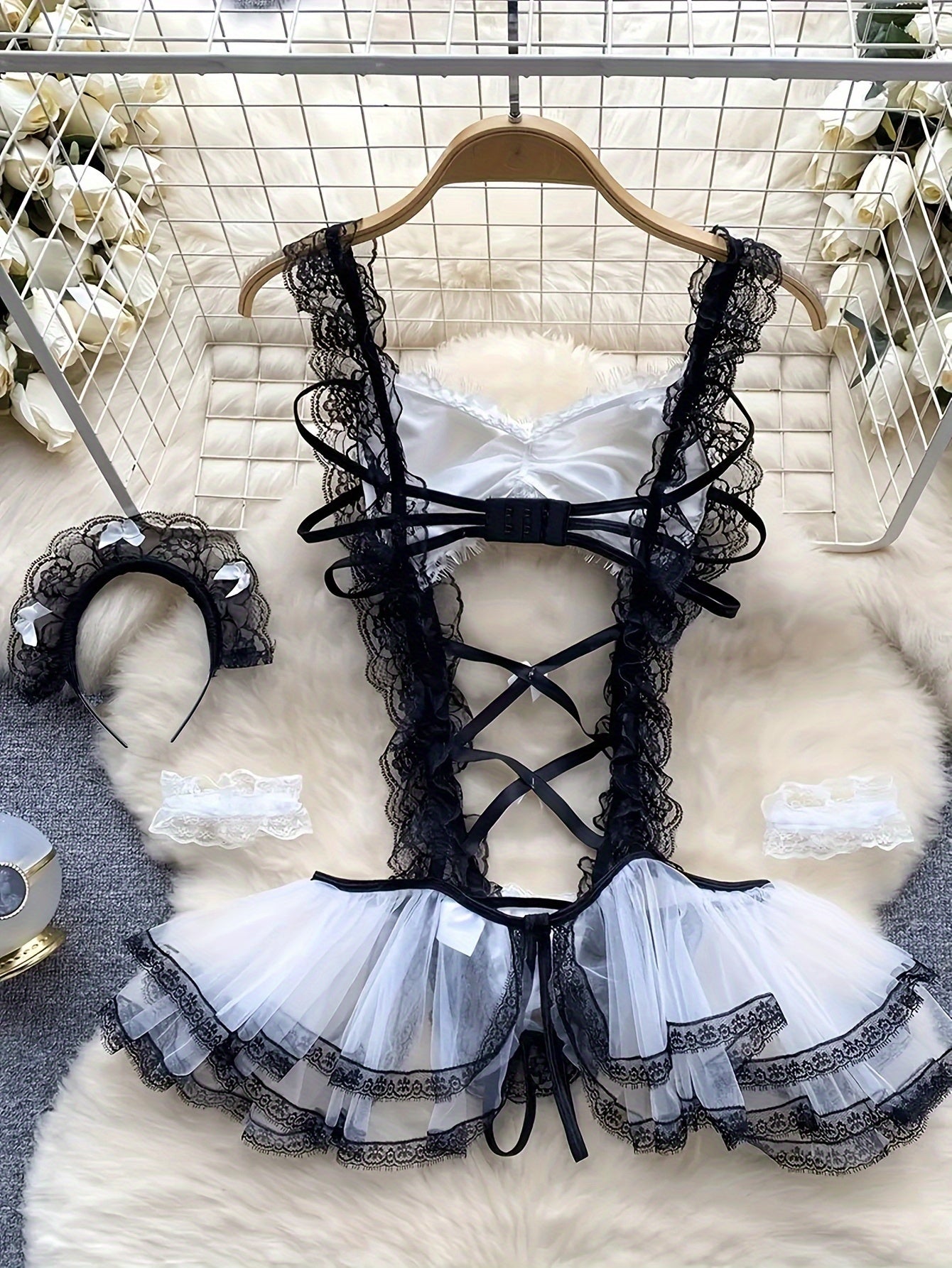 Women's sexy maid role play costume lingerie set with bodysuit, lace dress, suspender, bracelet, and headpiece.