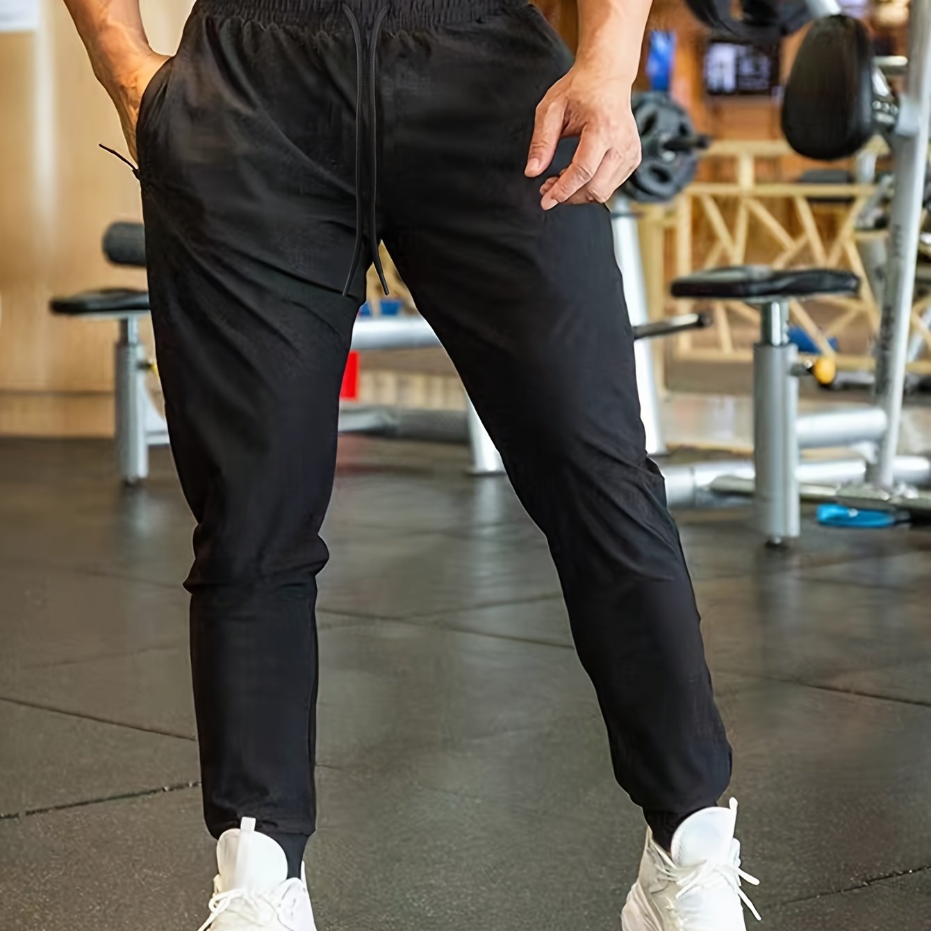 Men's athletic joggers in black made of breathable polyester with an elastic waistband and drawstring; suitable for gym, running, and casual wear.