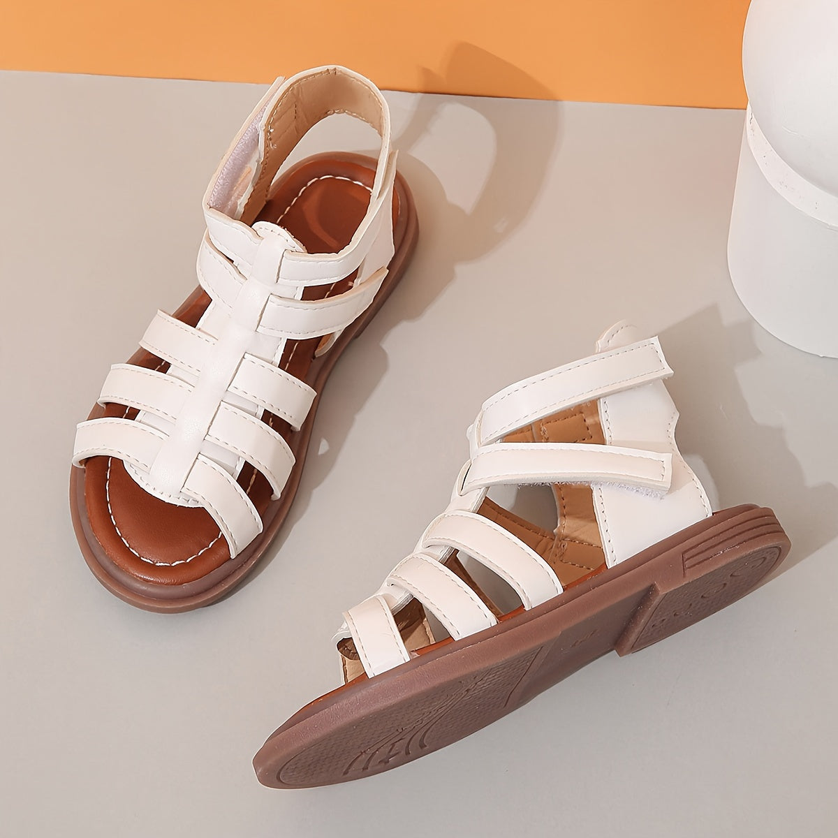 Ivory sandals for girls with brown sole, ideal for school and leisure activities.