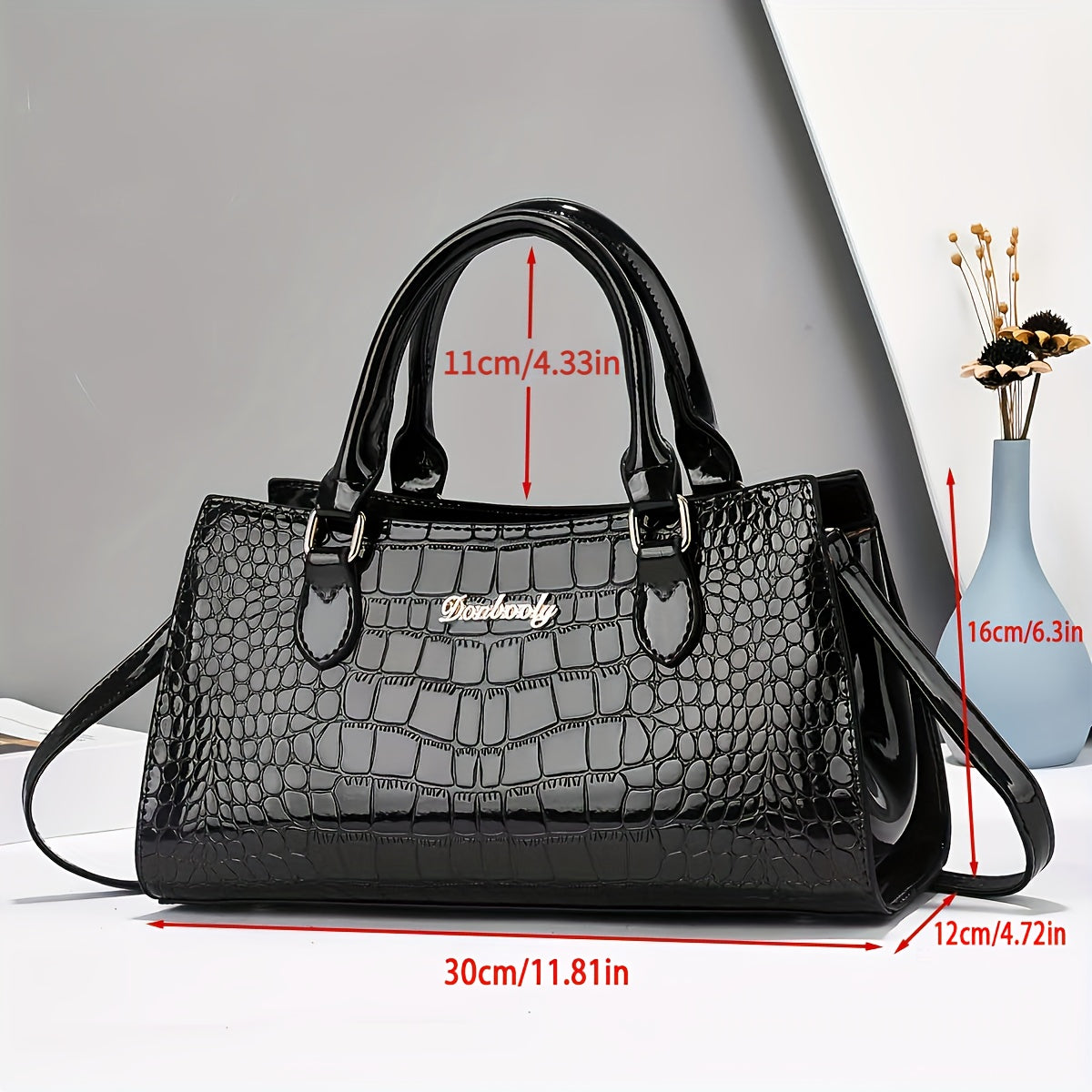 Fashionable black crocodile-embossed women's handbag with adjustable strap, zip closure, and wrist strap. Lightweight and versatile for everyday use, can be worn as a crossbody or shoulder