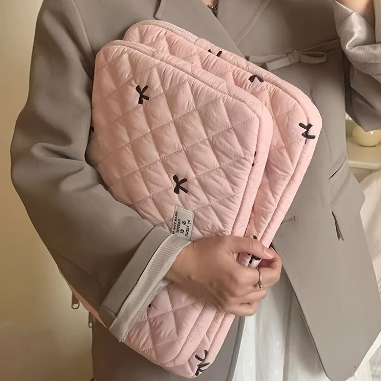 One laptop bag with ballet style bow embroidery, suitable for various devices.