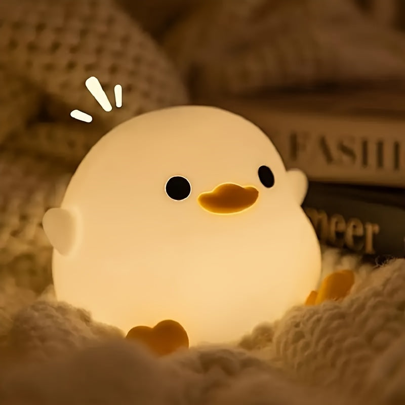 A whimsical Cute Duck-Shaped Table Lamp with a Geometric Pattern and White Matte Finish. This battery-powered lamp includes a switch, a plastic shade, and a G13 bulb base for ≤36V. Perfect for bedside reading or as a nursery night light, providing gentle