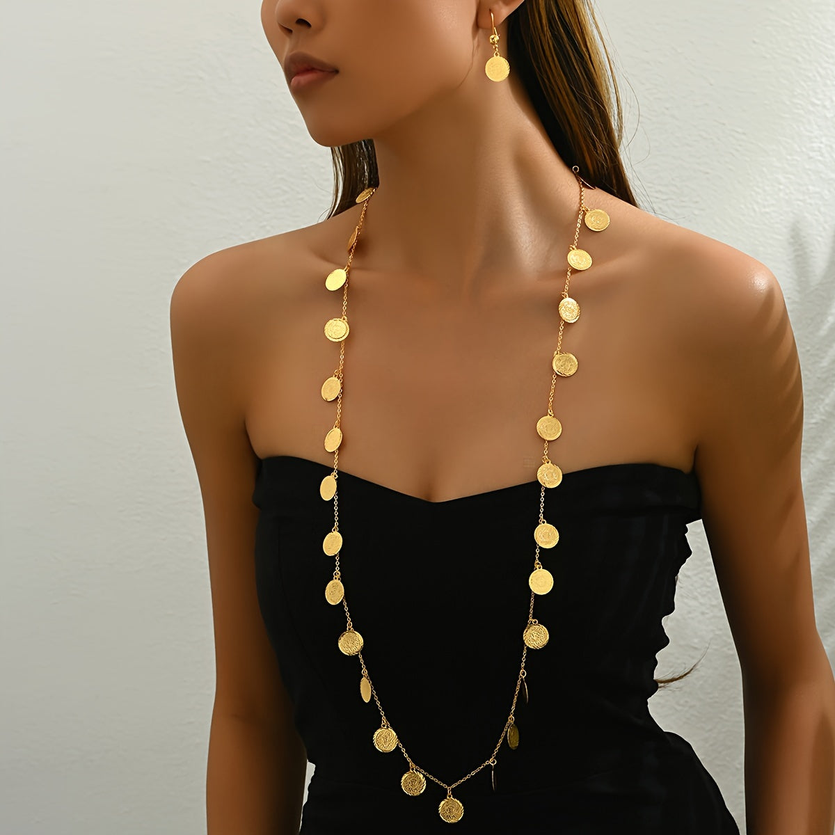 Introducing a new two-piece set featuring relief gold coins, a retro fashion long necklace, and matching earrings. This set exudes light luxury and is versatile for women looking to make a statement during Ramadan.