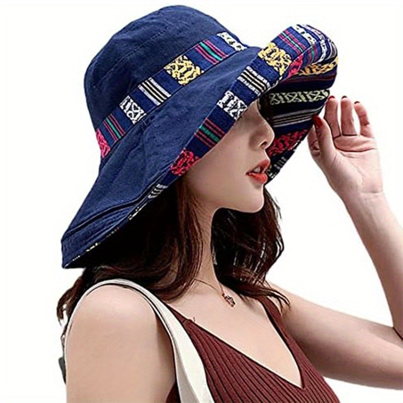 Reversible wide brim cotton bucket hat for women in dark blue with geometric pattern and multicolor accents. Great for travel and outdoor activities. Provides UV protection and