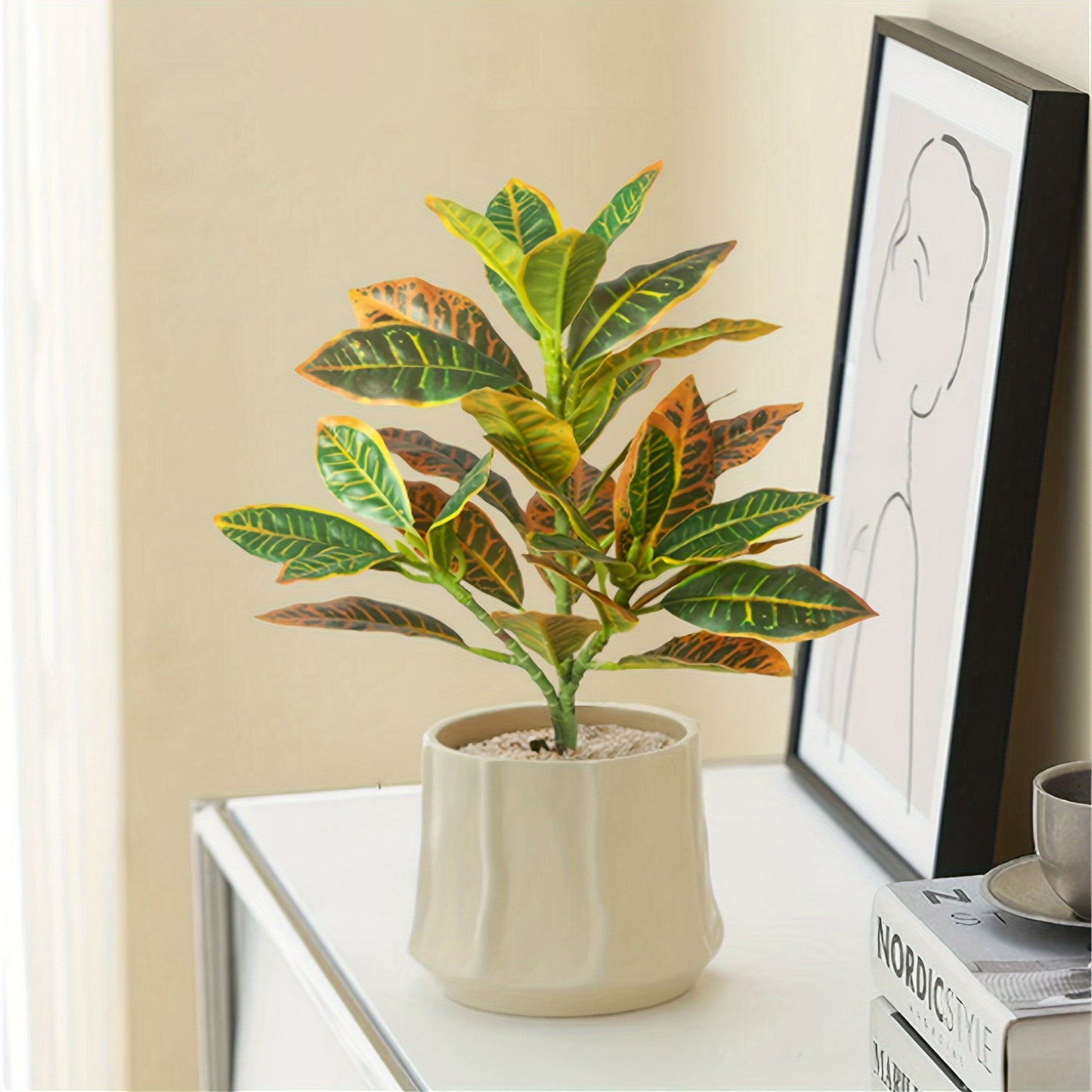 Stylish artificial croton plant with variegated leaves for home decor, perfect for any occasion - pot not included.