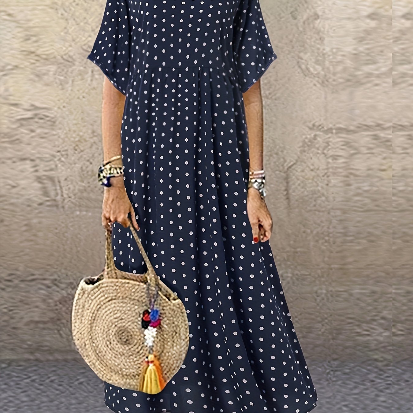 Machine washable navy blue midi dress with white polka dots, short sleeves, round neck, and ruffle detail.