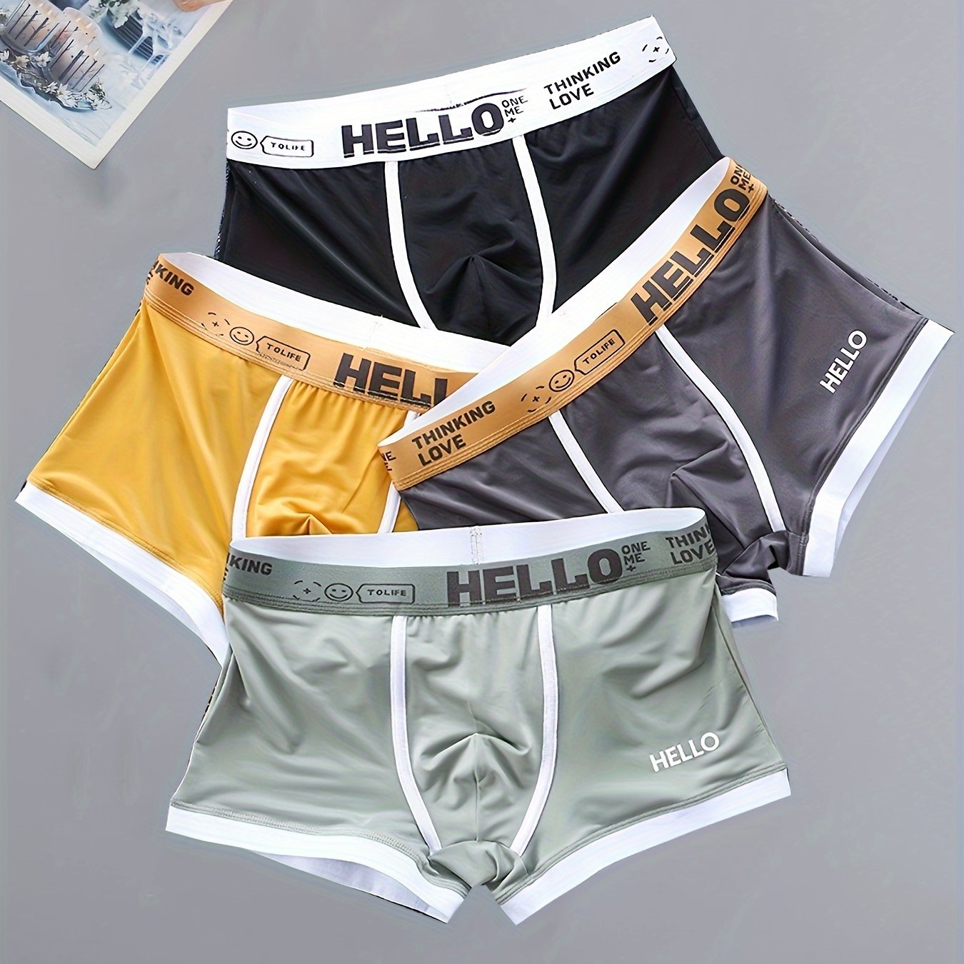 4 men's boxer briefs made with soft, breathable polyamide and elastane fabric featuring an alphabet pattern.