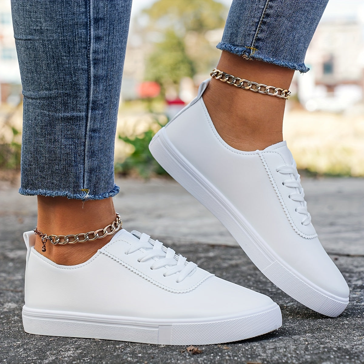 Versatile women's white sneakers with classic design, lace-up closure, round toe, and rubber sole for all seasons. Made with faux leather upper and comfortable fabric lining.