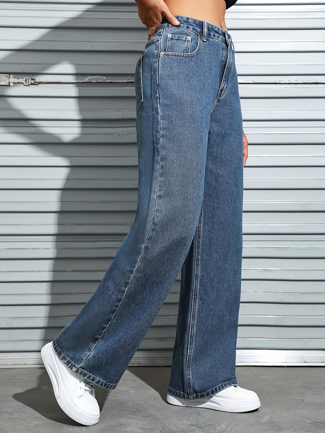 Women's plain washed blue loose fit jeans with slash pockets, perfect for casual autumn wear.