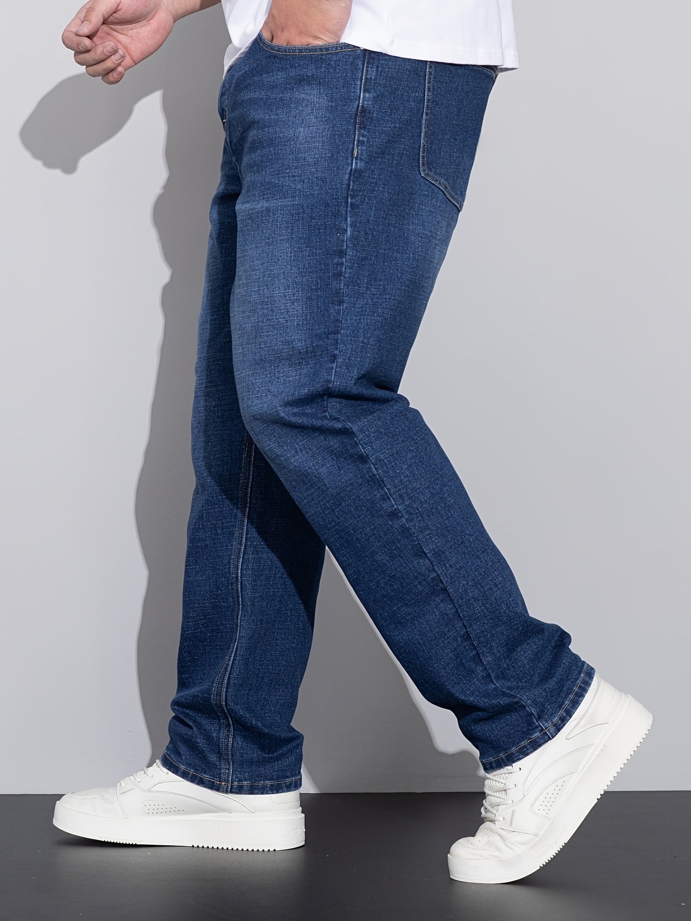 Men's stretchy cotton denim pants for all seasons, in a loose fit and plus size, perfect for business casual wear.