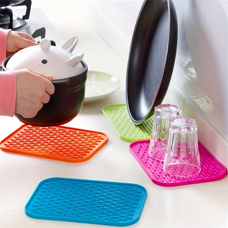 High-quality silicone drying mat for dishes, heat-resistant and non-slip, protects kitchen surfaces, versatile trivet, 21.59cm x 16.0cm, come in vibrant colors.