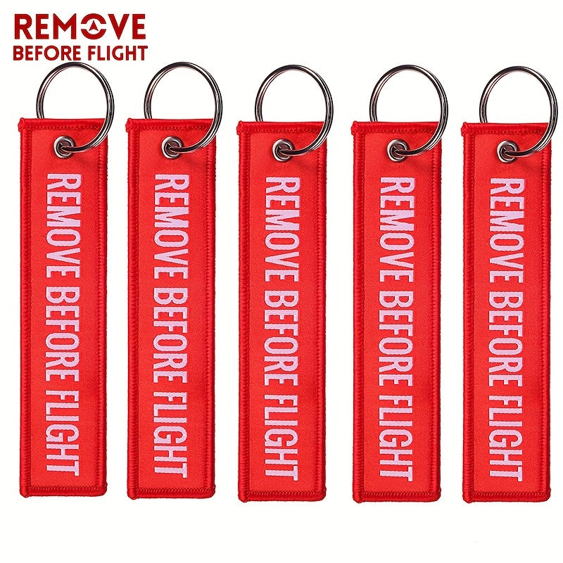 Bundle of 50 'Remove Before Flight' Woven Keychains made from sturdy polyester material - Ideal present for pilots and aviation fans, featuring the iconic phrase "REMOVE BEFORE FLIGHT