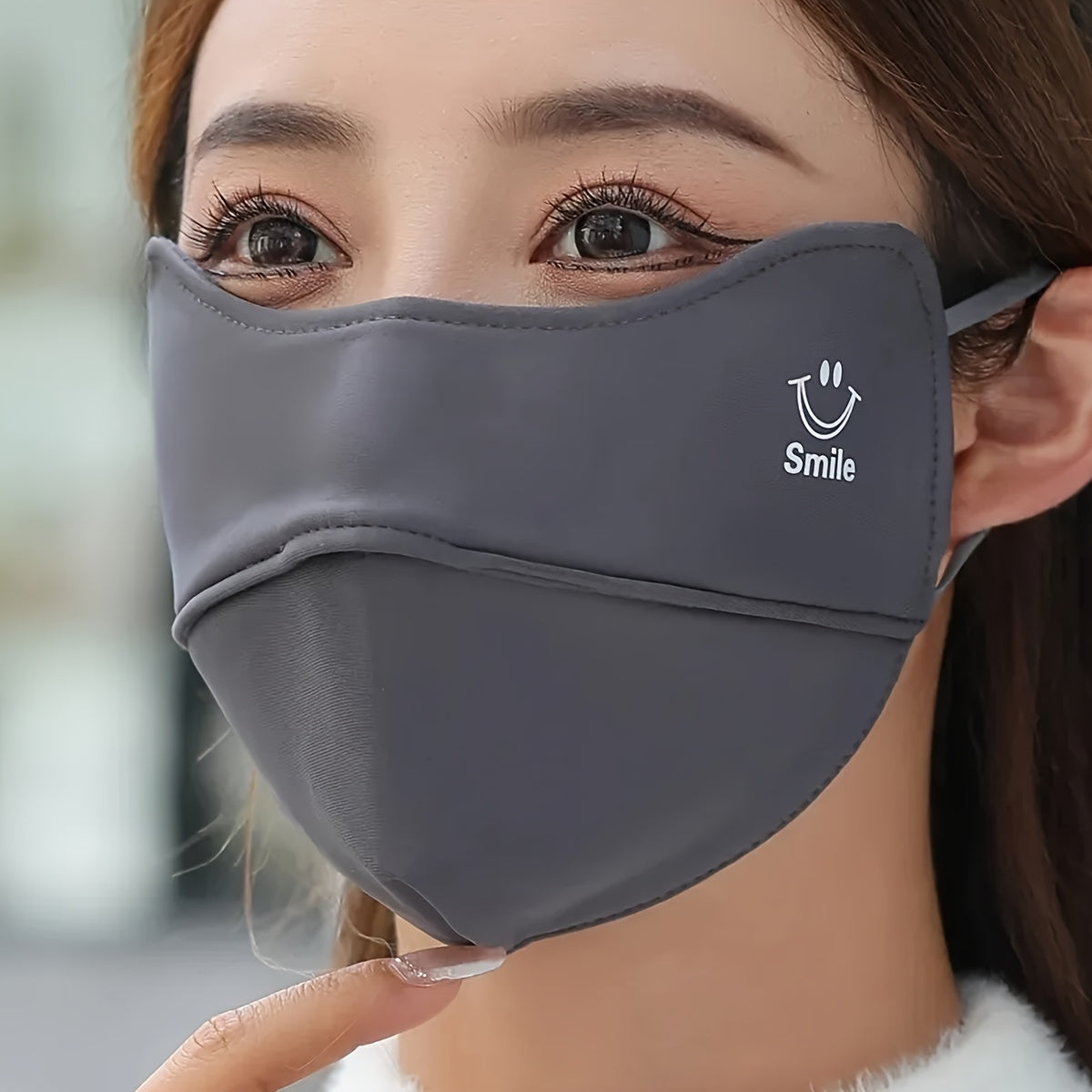 One adorable smiling graphic mask in a solid color, perfect for cycling and casual wear, provides windproof and dustproof protection for women.