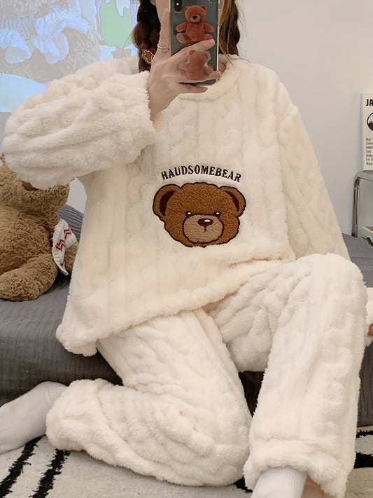 Warm and cozy winter plush pajama set for women with long sleeve teddy bear top and matching pants, made of soft polyester loungewear for cold weather comfort.