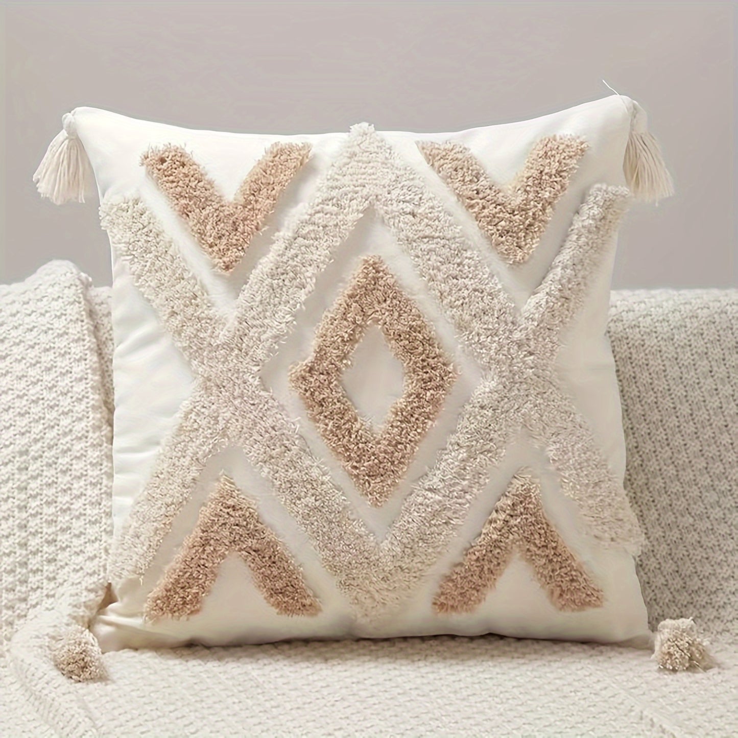 Boho beige tufted pillow cover with tassels and geometric diamond pattern, ideal for couch or bed. Made of polyester with zip closure, hand wash only. Insert not included.