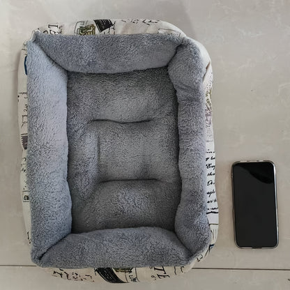 Soft light blue dog bed with newspaper print border, suitable for small, medium, and large dogs. Provides all-season warmth and comfort. Stylish and warm pet cushion.