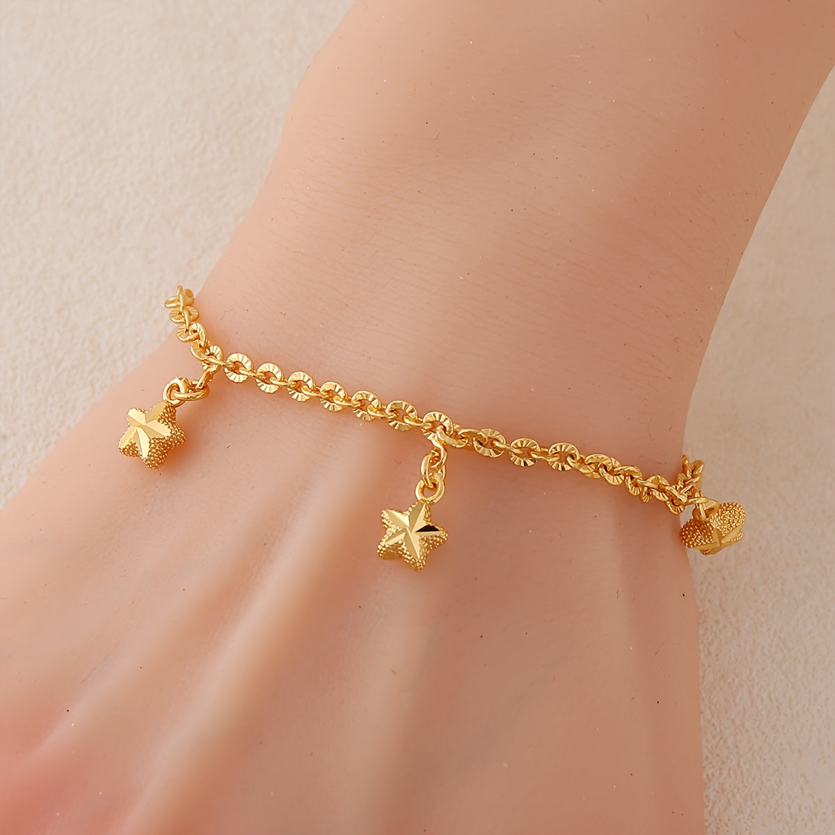 A charming bracelet featuring a simple star charm, plated in 24K gold. Made from copper material, this bracelet has an adjustable chain link wristband perfect for women. Ideal for daily wear, sports, and Mardi Gras Day, this accessory is suitable for all