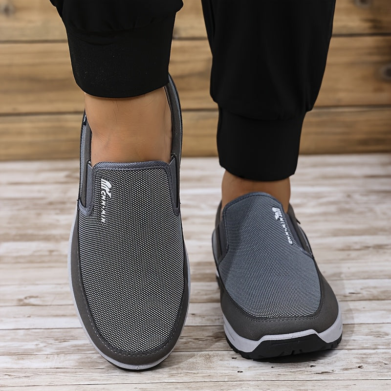 Men's slip-on sports sneakers with breathable fabric upper, round toe, and faux sole for daily wear and running.