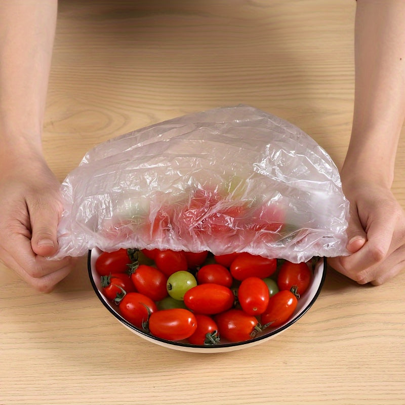 100 pieces of PVC elastic food covers - perfect for preserving freshness in fruits, rice, and in the refrigerator or freezer. These covers are leak-proof, dust-proof, adjustable, and reusable.