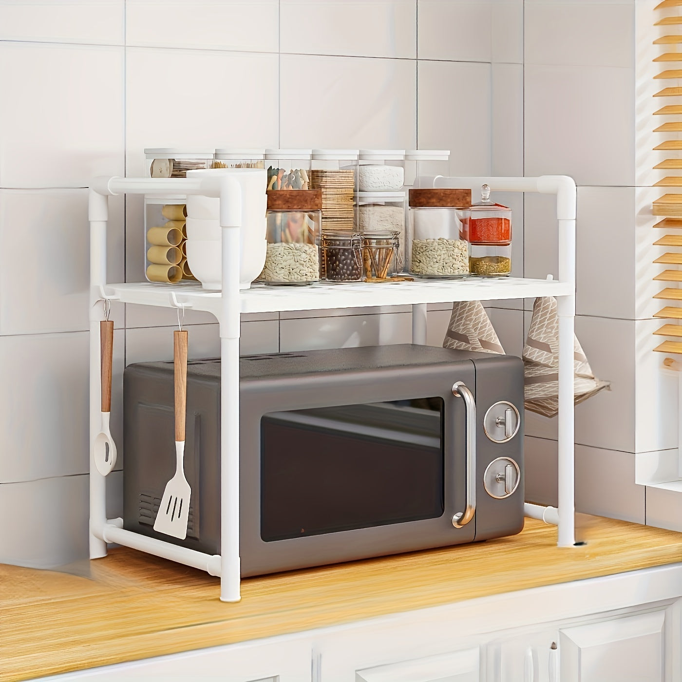 Ideal for countertop use, this adjustable kitchen storage rack is made of multi-tier carbon steel and features an open shelving organizer for your oven, rice cooker, and other kitchen appliances. The stand is designed with a mix of metal and plastic