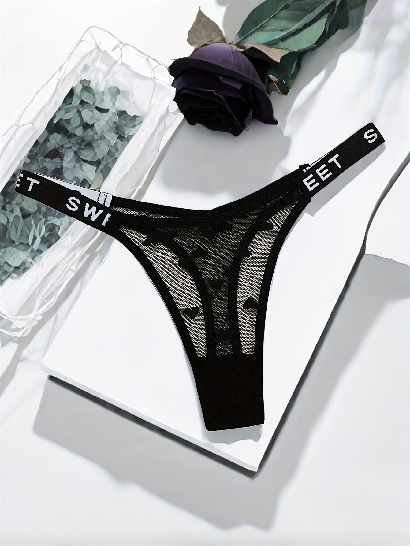 Stylish polyamide blend thong underwear with heart pattern, mesh design, and comfortable stretch fit.